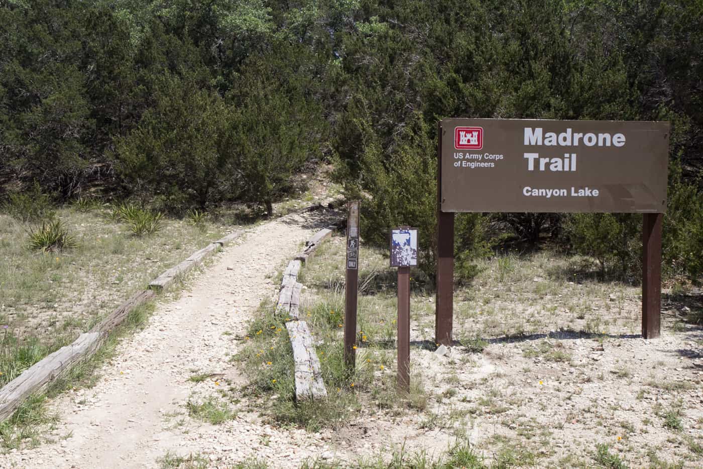 Canyon Lake Madrone Trail trailhead sign and gravel path at Canyon Lake