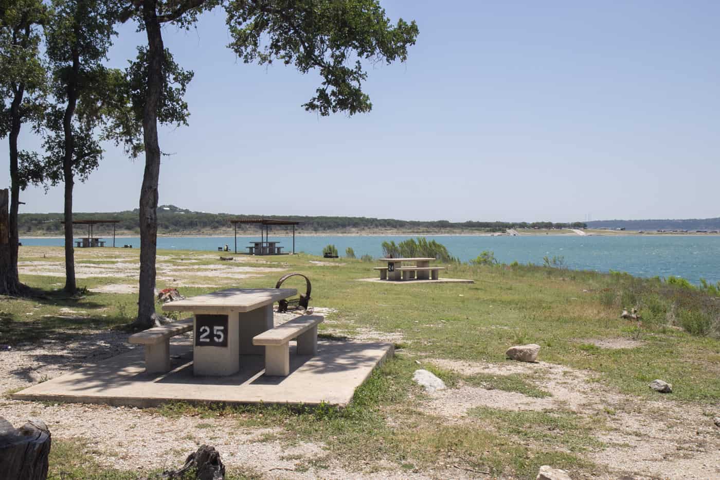 Lakeside picnic sites with shade trees and shelters on the Canyon Lake shore